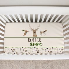 a baby crib with the name kotterr and two deers on it