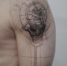 a man's shoulder with an abstract tattoo on it