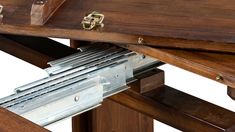 a close up of a wooden table with metal brackets on the top and bottom section