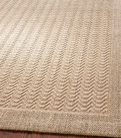 a beige rug with wavy lines on it