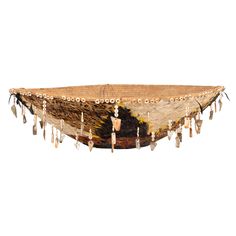 an old woven hammock with tassels hanging from it's sides