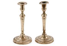 two antique brass candlesticks on white background