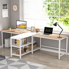 a computer desk with a laptop on top of it