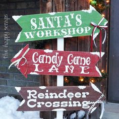 three wooden signs that say santa's workshop, candy cone lane and reindeer crossing