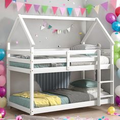 a white bunk bed sitting next to balloons