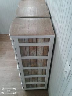 a wooden cabinet sitting next to a white wall