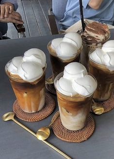 there are four cups with ice cream on them