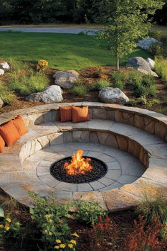 31 Outdoor Fire Pit Ideas for a Natural Look Flower Garden Around Fire Pit, Stone Round Fire Pit, In Ground Fire Pit With Seating, Conversation Pit Outdoor, Campfire Area, Fire Pit Ideas Backyard, Outdoor Fire Pit Ideas, Natural Fire Pit, Fire Circle