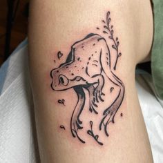 a tattoo on the leg of a woman with a dog's head and leaves