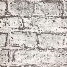 an old brick wall is shown in black and white