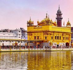 a large yellow building sitting on top of a lake