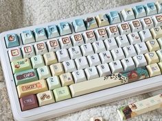 a computer keyboard sitting on top of a white carpet next to a pen and eraser