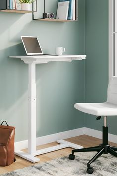 a laptop computer sitting on top of a desk next to a white chair in a room