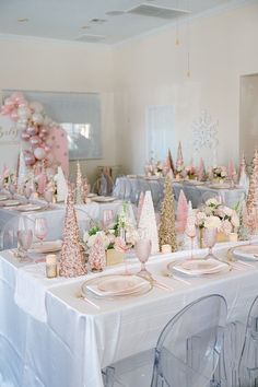 the table is set with pink and gold decorations for an elegant winter wedding reception in pastel tones