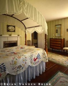 an old fashioned bedroom with a canopy bed