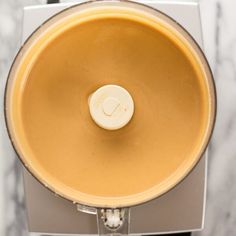 a food processor filled with liquid sitting on top of a counter