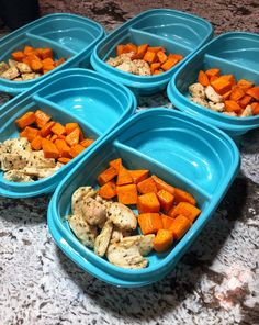 four blue bowls filled with food sitting on top of a marble counter next to each other