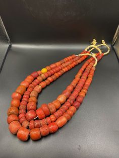 Lot of 3 two Vintage orange Glass African Trade Bohemian beads. There is a slight variation of color and shape in some beads. They all look hand made and slightly different. Good collectible beads, no visible wear or damage. Strung on a good nylon string, can be easily fashioned into a long necklace. Get creative! fast and free shipping Enjoy! Luxury Bohemian Orange Beads, Unique Luxury Orange Beads, Orange Large Beads For Jewelry Making, Large Orange Beads For Jewelry Making, Unique Polished Orange Beads, Hand-strung Orange Bohemian Beads, Bohemian Hand-strung Orange Beads, Large Oval Orange Beads, Traditional Orange Wooden Beads