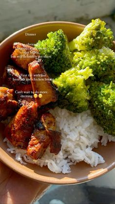 a bowl filled with rice, broccoli and chicken on top of it's side