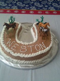 there is a cake that has horses on it and the name nelson written in frosting