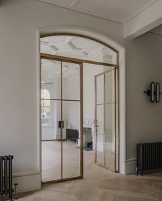 an empty room with large glass doors and wooden parquets on the floor in front of it