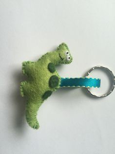 a stuffed animal keychain with a green frog on it