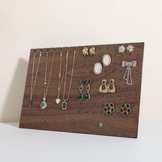 a wooden display with various jewelry on it