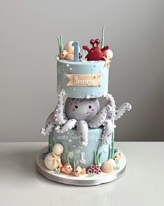 there is a cake that has an octopus on the top and crab on the bottom