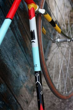 a close up of a bike tire and spokes on the front wheel, with an arrow painted on it