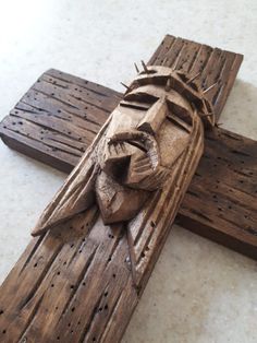 a wooden crucifix with a statue of jesus on it