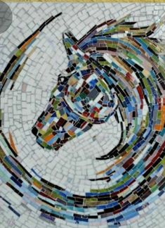 a mosaic horse head on a yellow wall