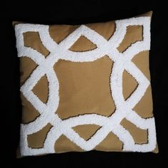 a brown and white pillow on a black background