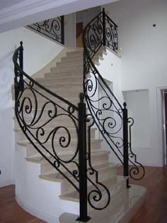 a staircase with wrought iron handrails in a home