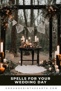 an outdoor wedding ceremony with candles and flowers on the table, surrounded by greenery