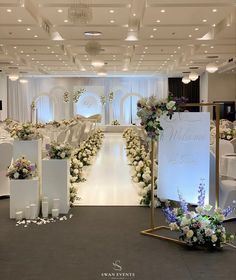 an indoor wedding venue with white and purple flowers