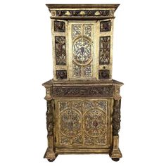 an ornate wooden cabinet with carvings on it