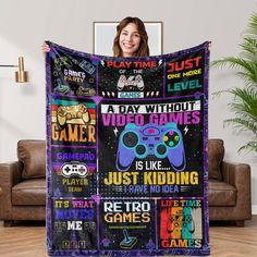 a woman holding up a blanket with video games on it