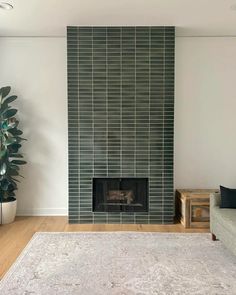 a living room with a couch, fireplace and rug