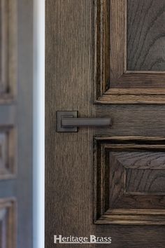 a close up of a door handle on a wooden door