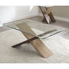 a glass table with wooden legs in a living room