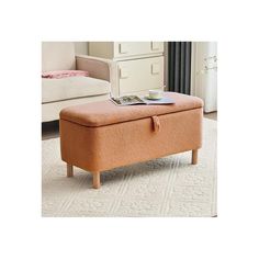 an orange ottoman sitting on top of a white rug