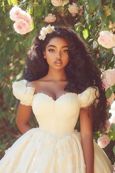 a woman wearing a white dress standing in front of flowers