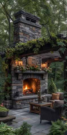 an outdoor fireplace surrounded by greenery and furniture