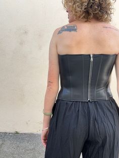 Miaou Black Vegan Leather Bustier. A super sexy black vegan leather sleeveless bustier with a spiky neckline that makes it even more badass. Boning adds structure, has some stretch for a snug fit. Zipper closure up the back. Shell is a vegan leather is made from a poly-rayon blend, lining is a recycled poly-spandex blend. Marked size S. In excellent, like-new condition. Approximate Measurements: Underarm to underarm: 16.5" Length: 13.5" Waist: 14.5" across Fitted Boned Bodice Crop Top For Club, Boned Bodice Sleeveless Tube Top For Club, Bandeau Fitted Corset For Club, Chic Corset With Boning For Club, Club Tube Top With Boned Bodice, Edgy Strapless Corset For Party, Fitted Corset With Back Zipper For Night Out, Cropped Corset With Boned Bodice For Night Out, Fitted Bandeau Corset For Club