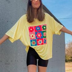 Adorable Light Banana Yellow Graphic Tee. With 9 Different 90's Pop Art Style Smiley Face Flowers In The Colors Light Pink, Green, Light Yellow, Hot Pink, & Blue. Each Flower Is Unique And Has A Different Color Way & Design; Including Lighting, Waves, Zebra Print, & Checkers. The Tee Has An Oversized Look And Features Oversized Sleeves & A Longer Length. This Would Be Perfect Paired With Biker Shorts Or Could Be Styled Tied In A Knot At The Bottom. 82% Polyester, 15% Rayon & 3% Spandex Model Is Yellow Oversized Crew Neck Tops, Oversized Yellow Crew Neck Top, Casual Yellow Spring Top, Casual Yellow Top For Spring, Oversized Yellow T-shirt For Spring, Casual Neon Yellow Short Sleeve Tops, Yellow Relaxed Fit Tops, Yellow Graphic Print T-shirt, Neon Yellow Cotton T-shirt For Spring