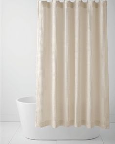 a white shower curtain in a bathroom