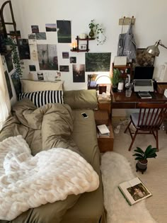 a bedroom with a bed, desk and computer