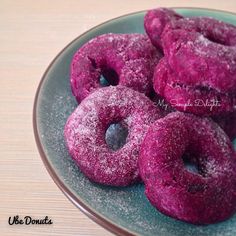 powdered doughnuts on a plate with blueberries