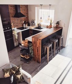 a kitchen with an island in the middle and lots of stools around it's perimeter