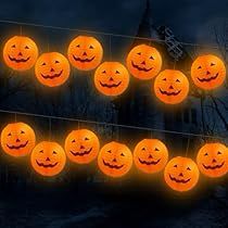 a bunch of pumpkins that are glowing in the night sky with faces on them